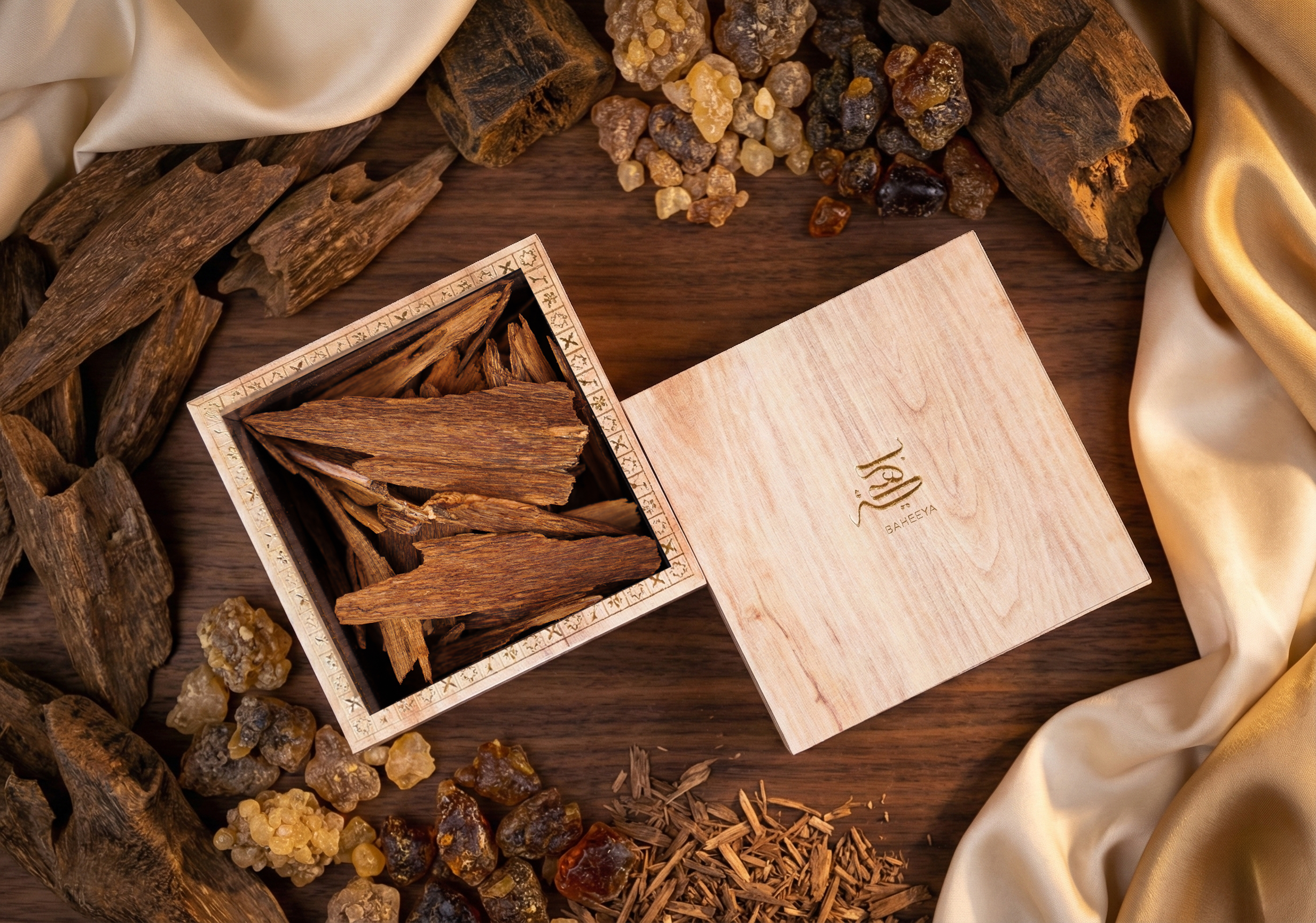 Wooden box with incense sticks on a wooden surface with incense pieces around