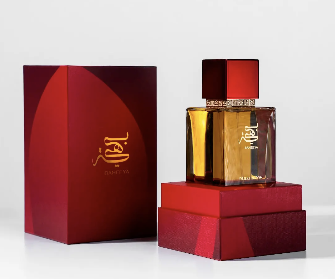 Perfume bottle and packaging with a red box on a white background